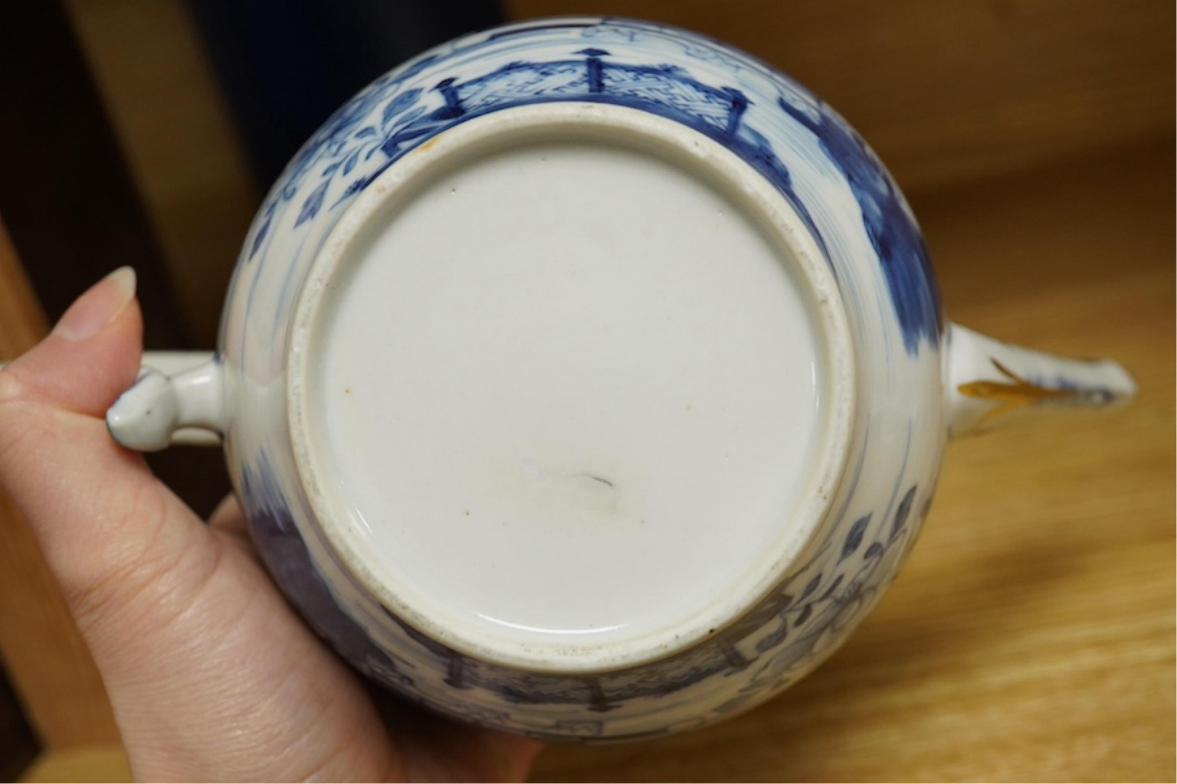 A Chinese export blue and white teapot, c.1790, painted with pagodas, 24cm wide. Condition - some chipping and firing cracks